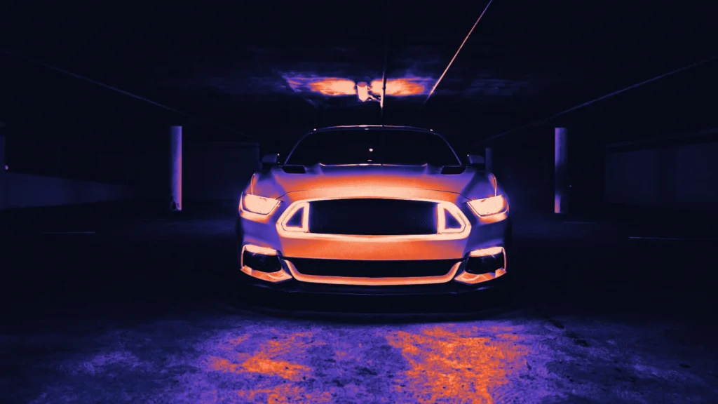 A sports car with glowing headlights in a tunnel, in Arcsen colours
