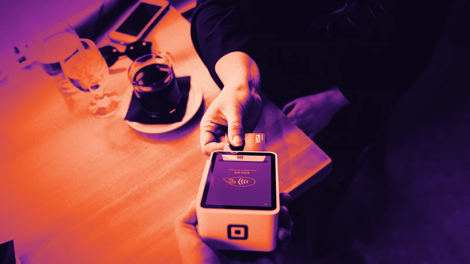 A customer paying by card at a payment terminal, in Arcsen colours