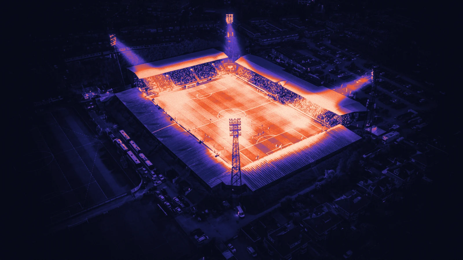 A floodlit stadium at night, seen from above, in Arcsen colours