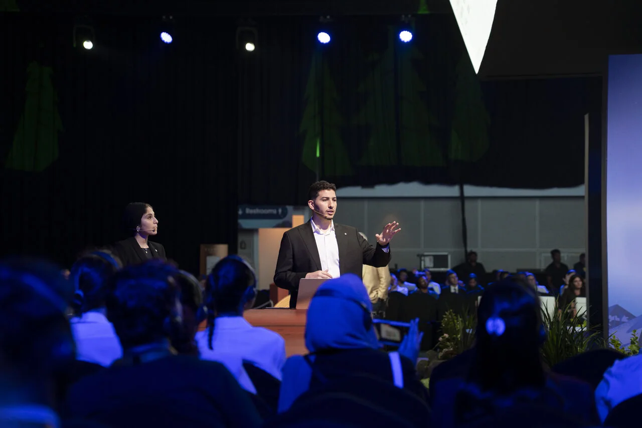 An Arcsen consultant presenting the automotive session, with the audience in the foreground, at Agentforce World Tour Dubai 2025