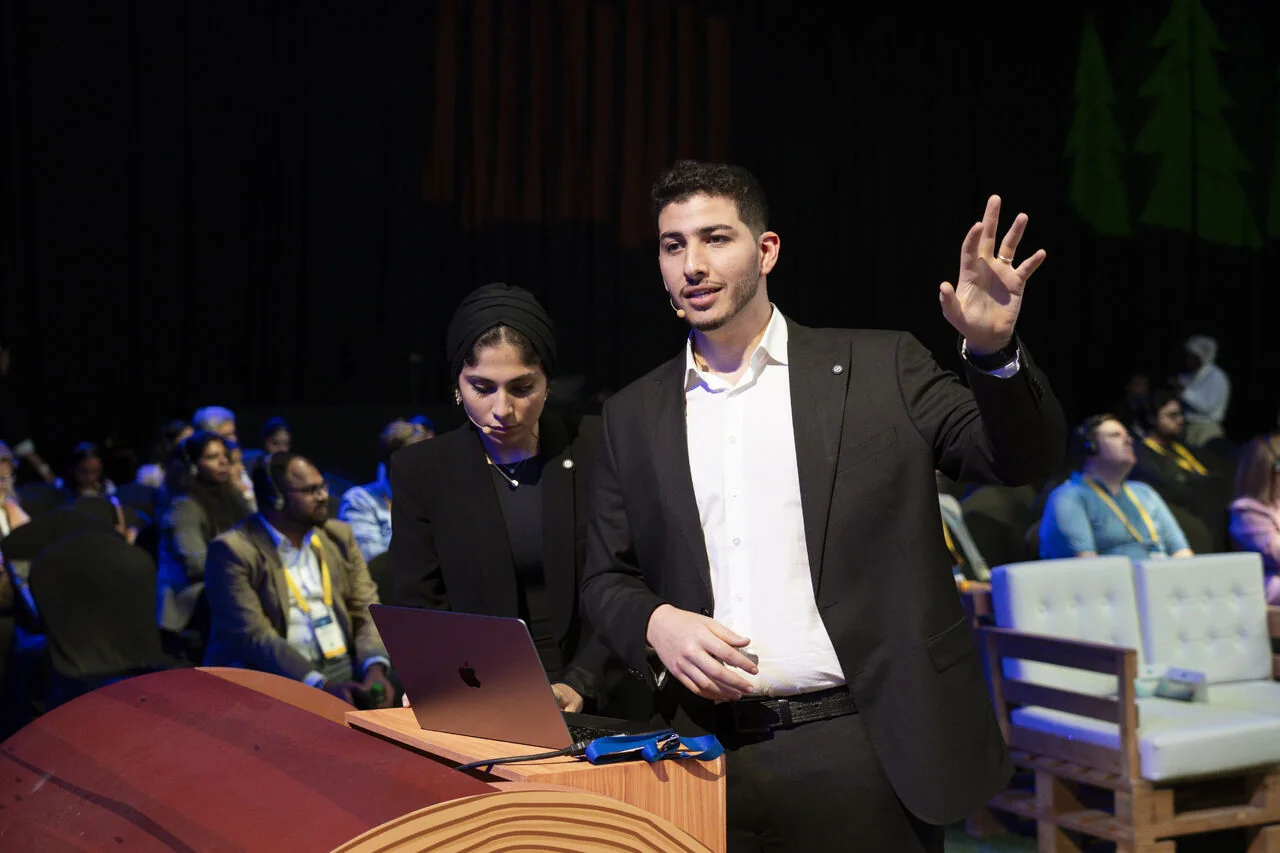 Two Arcsen consultants at the podium presenting the automotive session to an audience at Agentforce World Tour Dubai 2025