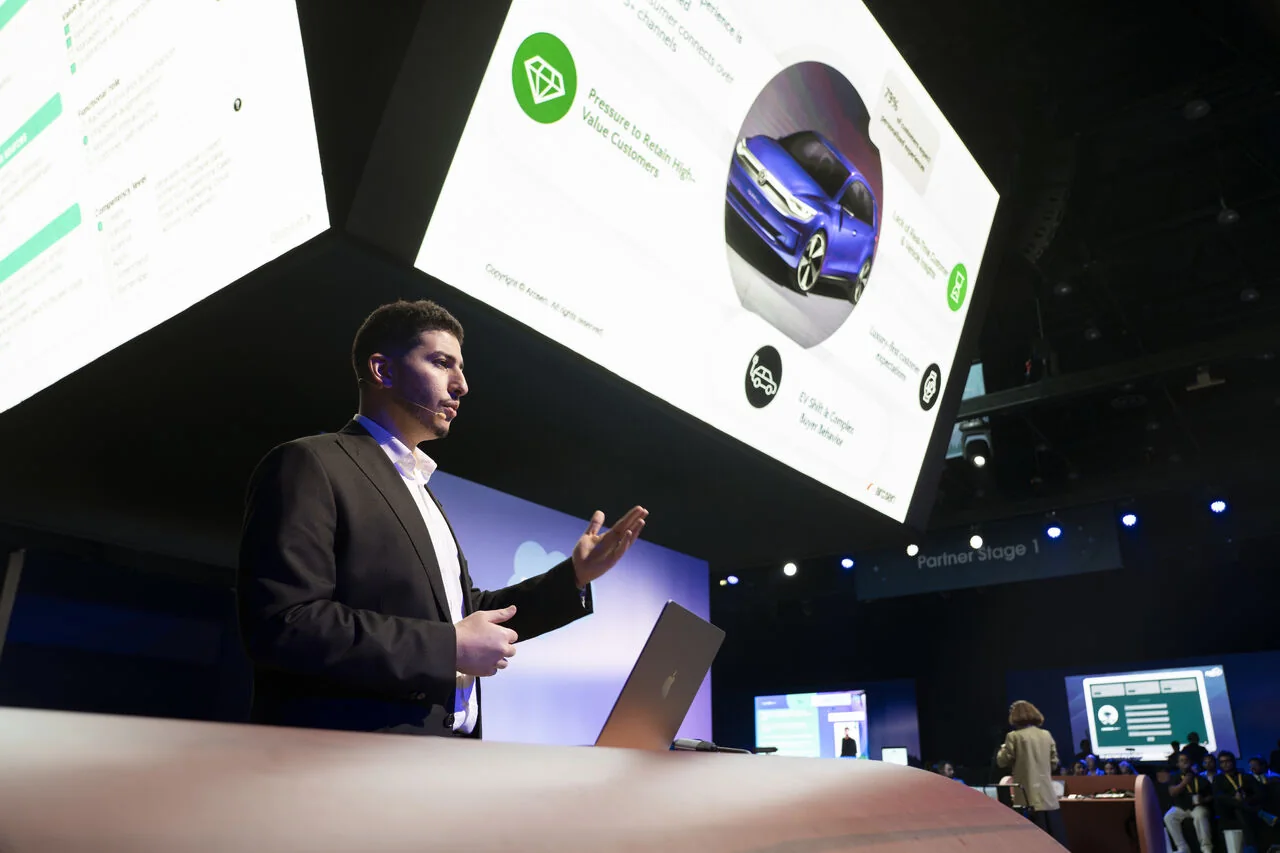 An Arcsen consultant presenting on the partner stage at Agentforce World Tour Dubai 2025