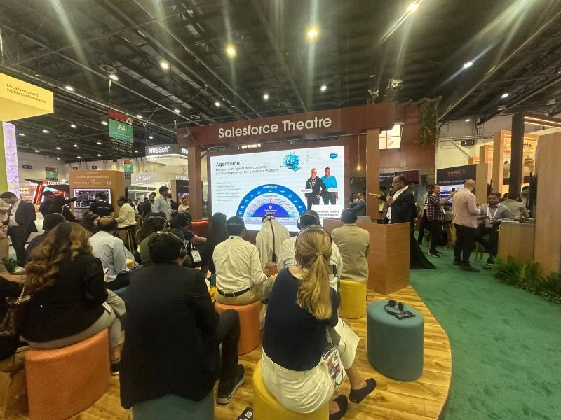 An audience seated in the Salesforce Theatre at GITEX Global 2024, facing a screen with a slide about Agentforce