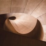 Spiral architecture descending into darkness — a visual metaphor for platform migration