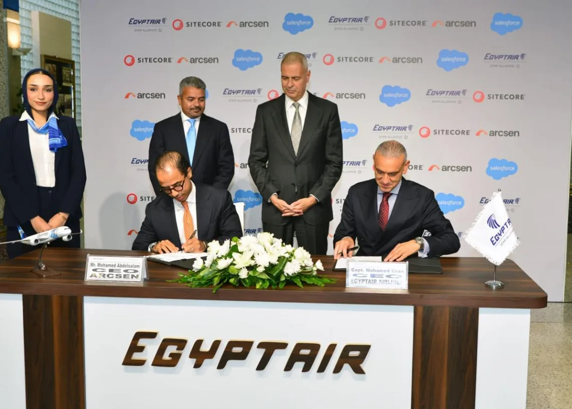 Signing ceremony: Arcsen CEO Mohamed Abdelsalam and EgyptAir Airlines leadership sign the SitecoreAI agreement in front of an EgyptAir, Sitecore, Arcsen and Salesforce backdrop